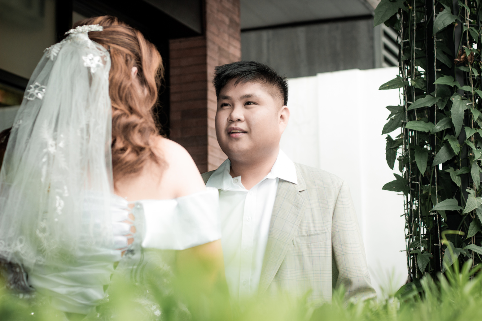Image of groom looking intimately to his bride