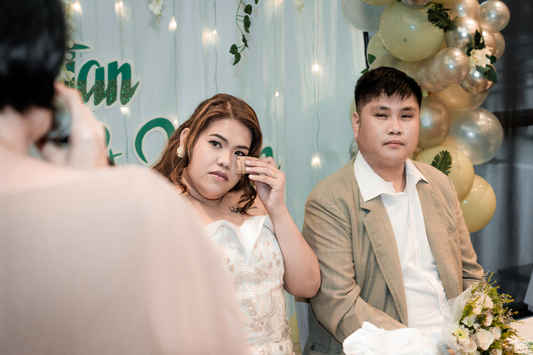 a bride and a groom crying on a wedding