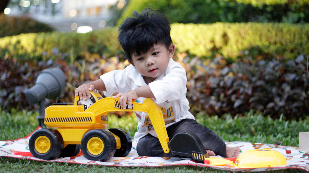 Image of a boy playing with a construction toy