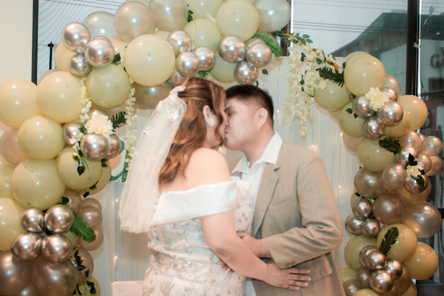 A Couple kissing on a wedding
