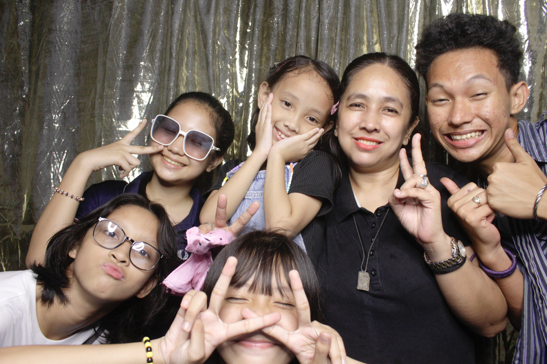 people happily posing on photobooth