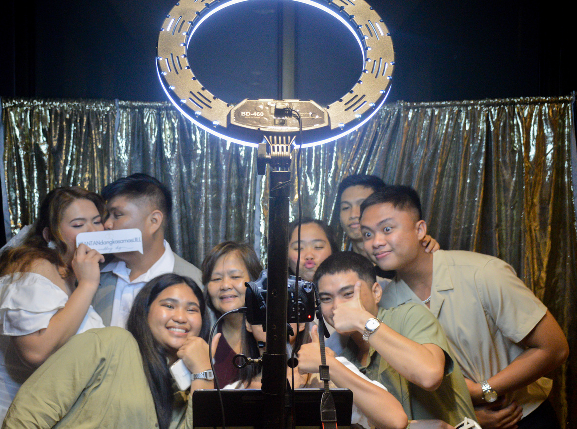 Photo of people taking a photobooth shot